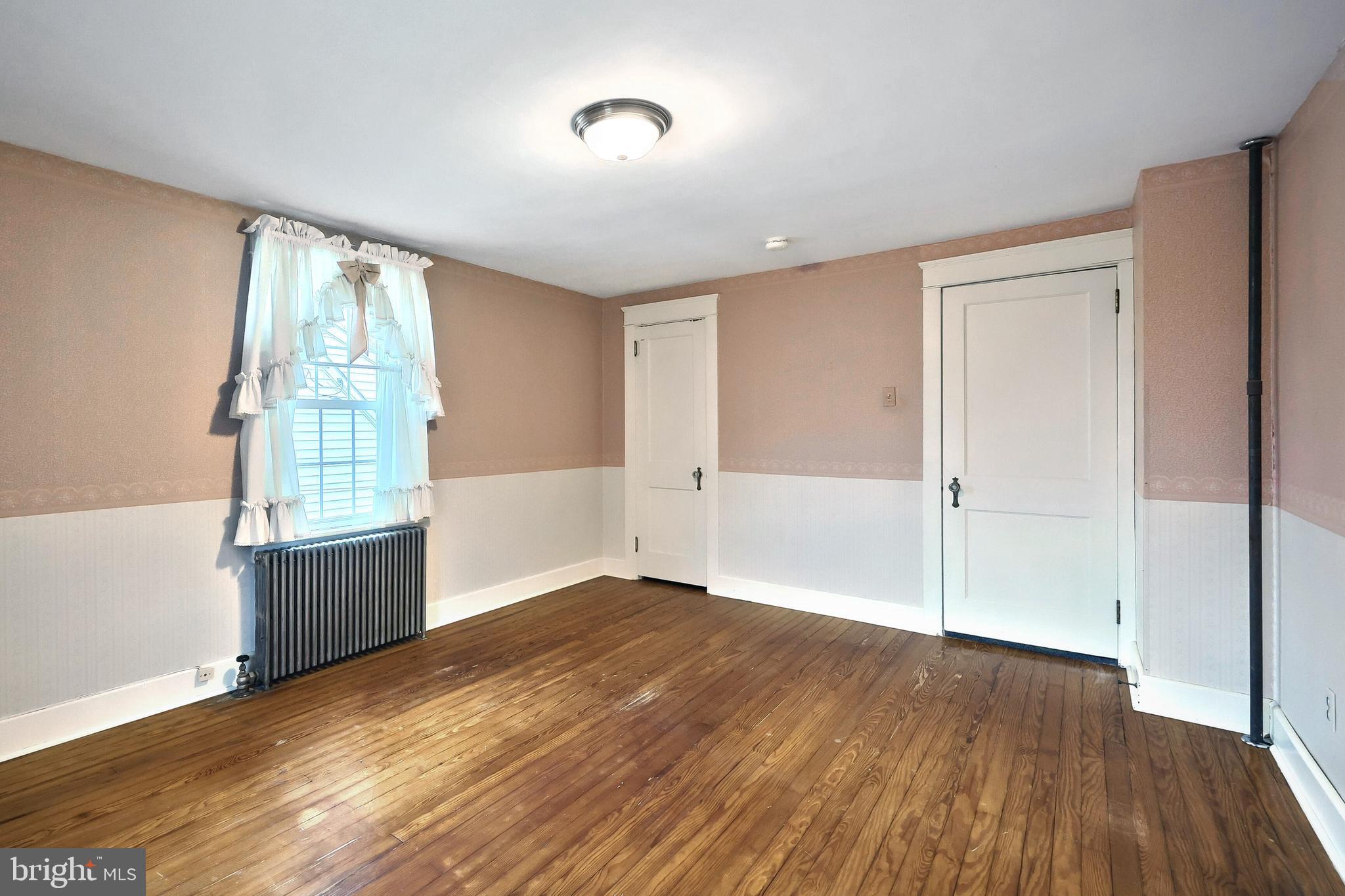 99 5th Street Hanover, PA 17331 - Photo 22 of 38 an empty room with wooden floor and windows