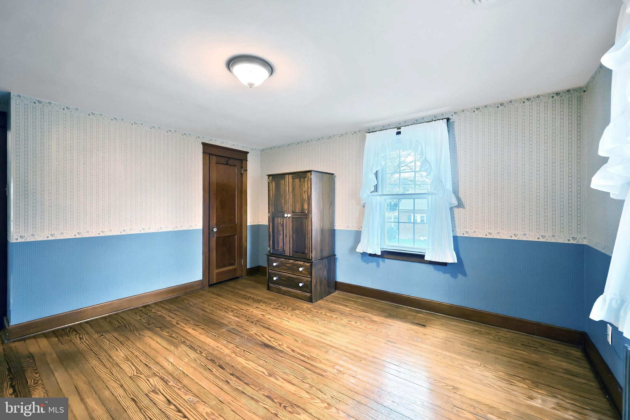 99 5th Street Hanover, PA 17331 - Photo 23 of 38 a view of an empty room with window and wooden floor