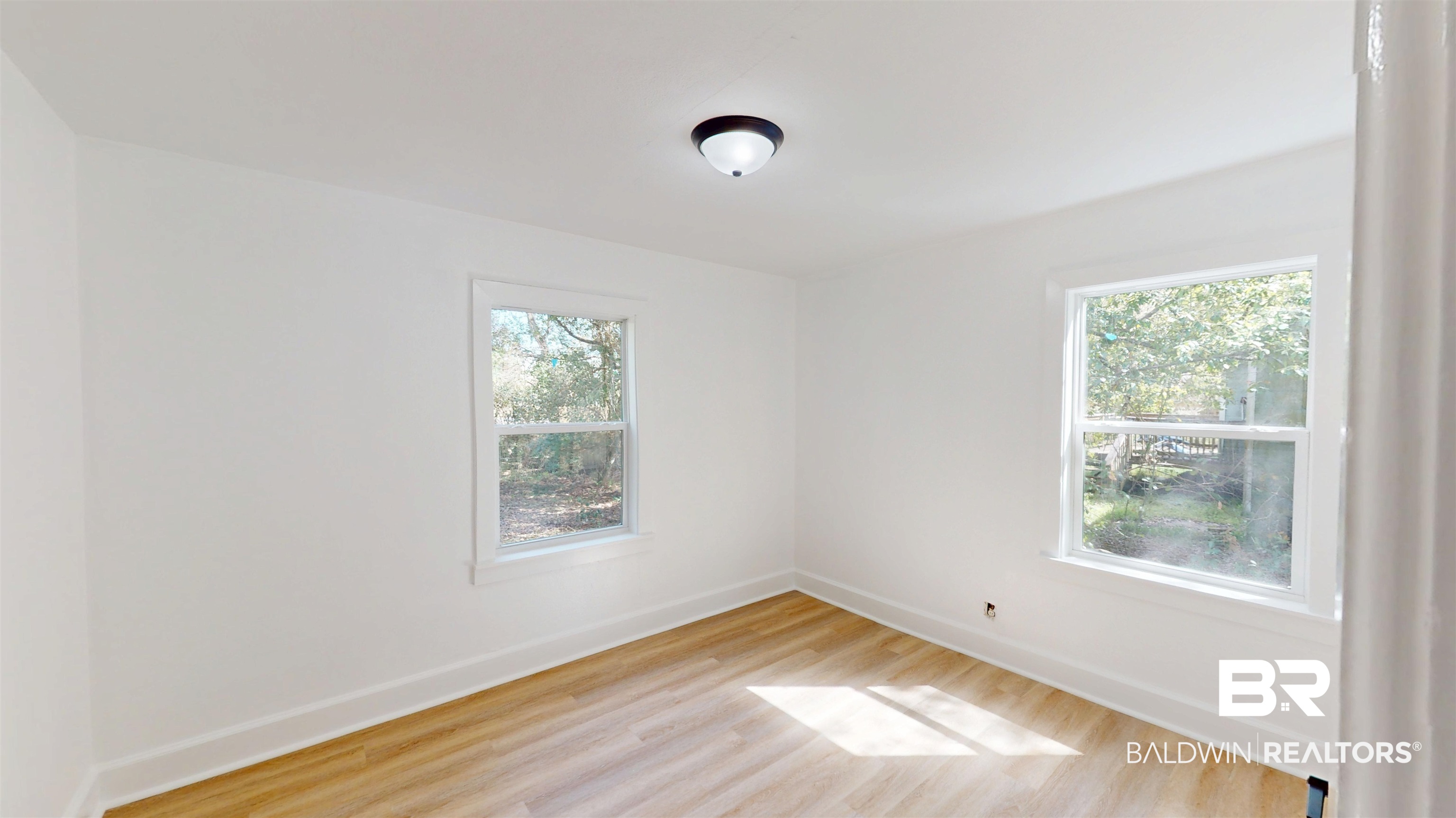 606 Shady Oak Drive Mobile, AL 36608 - Photo 9 of 14 Empty room featuring baseboards and light wood finished floors