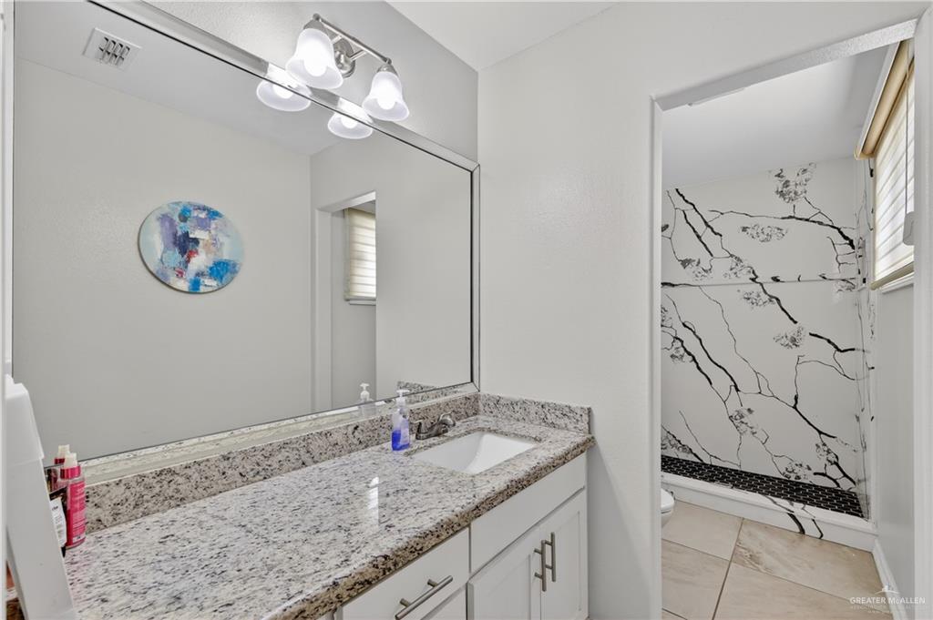 500 Wichita Avenue McAllen, TX 78503 - Photo 17 of 22 a bathroom with a granite countertop sink and a mirror