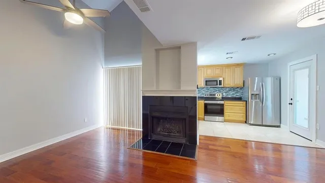 a view of a big room with wooden floor and closet in a room