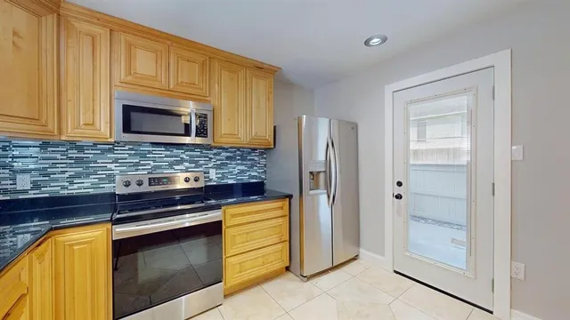 a kitchen with granite countertop a sink and cabinets