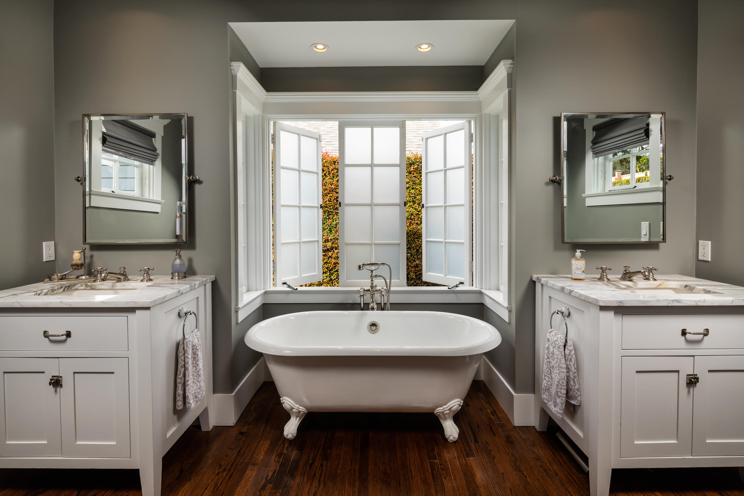 199 Ocean View Avenue Carpinteria, CA 93013 - Photo 15 of 19 a spacious bathroom with a granite countertop sink a mirror and a window