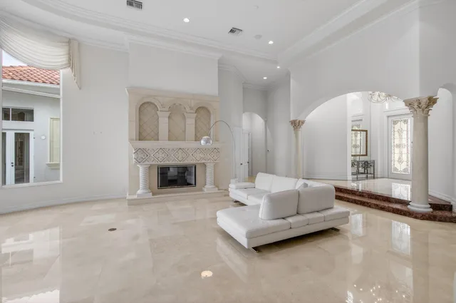 a spacious bedroom with a bed and a flat screen tv