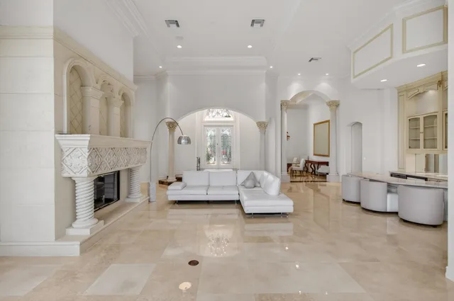 a living room with a bed furniture and a chandelier