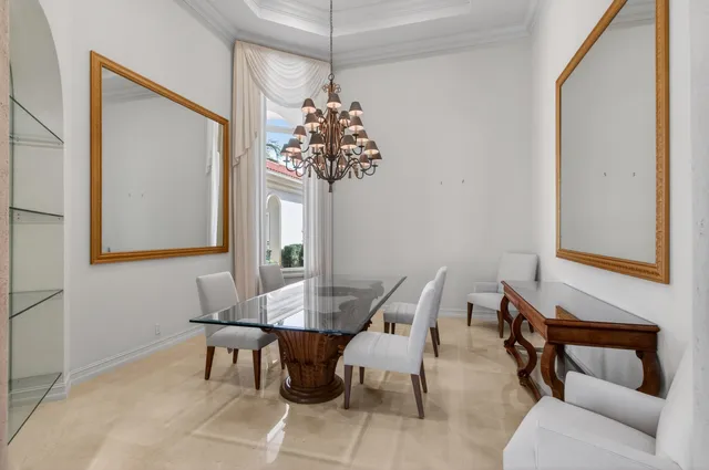 a view of a dining room with furniture a chandelier and wooden floor