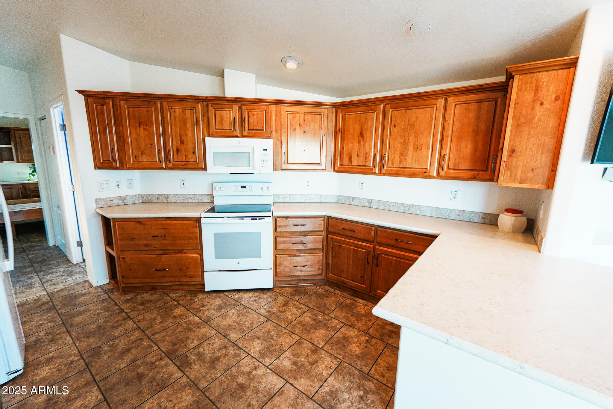 17200 West Bell Road, Unit 330 Surprise, AZ 85374 - Photo 15 of 39 a kitchen with stainless steel appliances granite countertop a stove a sink and a microwave
