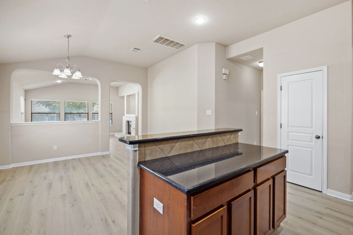 1900 Main Street Cedar Park, TX 78613 - Photo 12 of 34 a kitchen that has a kitchen island wooden floor and window