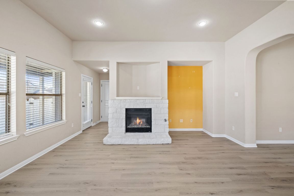 1900 Main Street Cedar Park, TX 78613 - Photo 17 of 34 an empty room with wooden floor fireplace and windows
