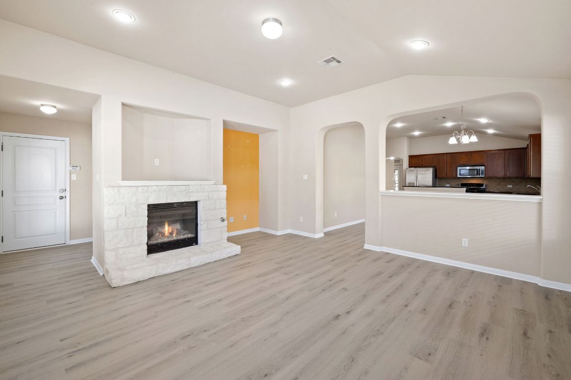 1900 Main Street Cedar Park, TX 78613 - Photo 18 of 34 an empty room with wooden floor and a fireplace