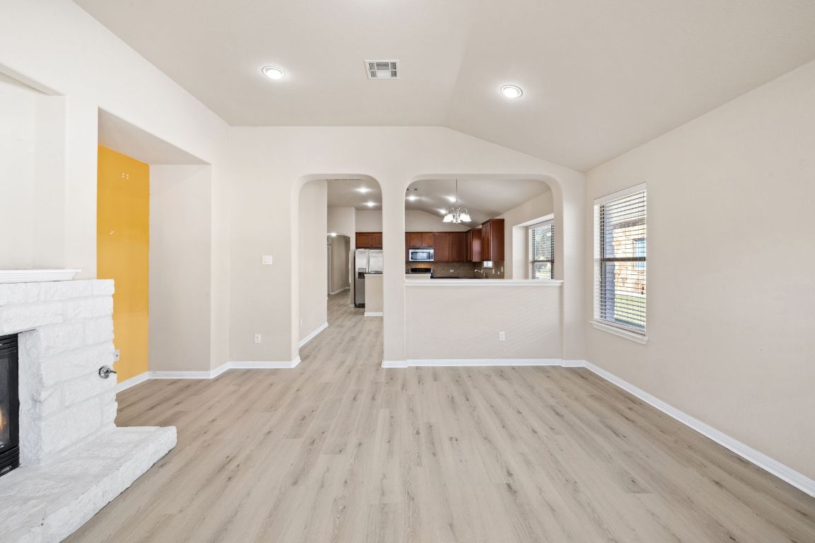 1900 Main Street Cedar Park, TX 78613 - Photo 19 of 34 a view of a living room and kitchen with wooden floor