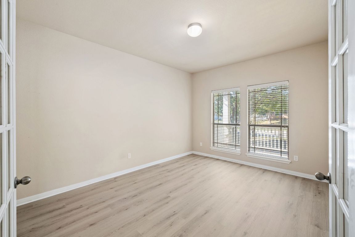 1900 Main Street Cedar Park, TX 78613 - Photo 21 of 34 an empty room with wooden floor and windows