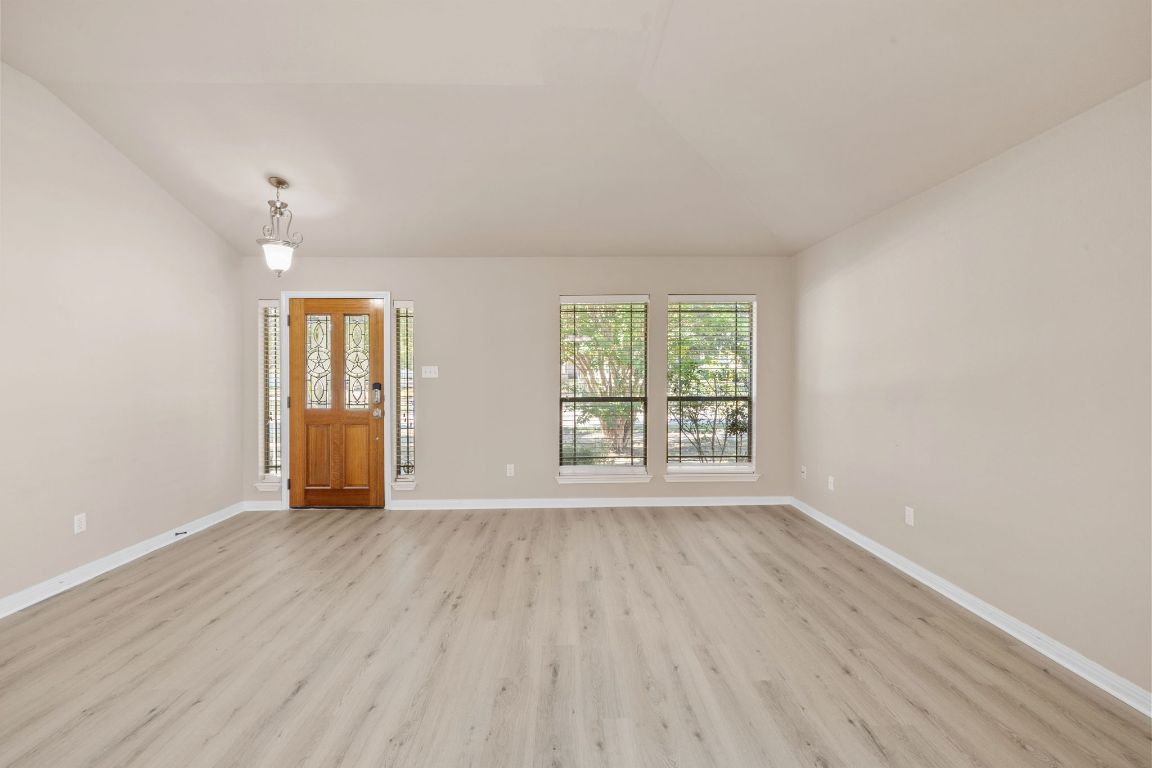 1900 Main Street Cedar Park, TX 78613 - Photo 7 of 34 an empty room with wooden floor and windows