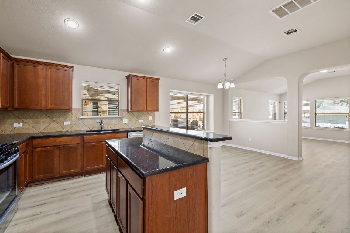 1900 Main Street Cedar Park, TX 78613 - Photo 10 of 34 a kitchen with granite countertop a sink counter top space and cabinets