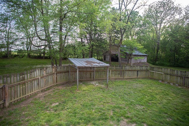 3220 Les Chappell Road Spring Hill, TN 37174 - Photo 69 of 70 a view of a deck and yard with wooden fence and large trees