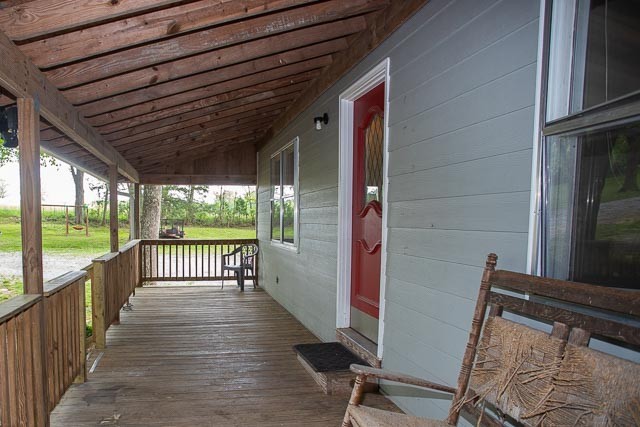 3220 Les Chappell Road Spring Hill, TN 37174 - Photo 10 of 70 a view of a porch with wooden floor and outdoor seating