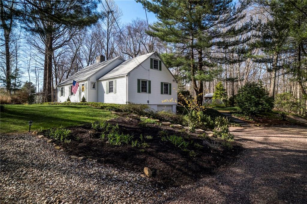 100 Robin Ridge Drive Madison, CT 06443 - Photo 1 of 1 a backyard of a house with lots of plants and trees