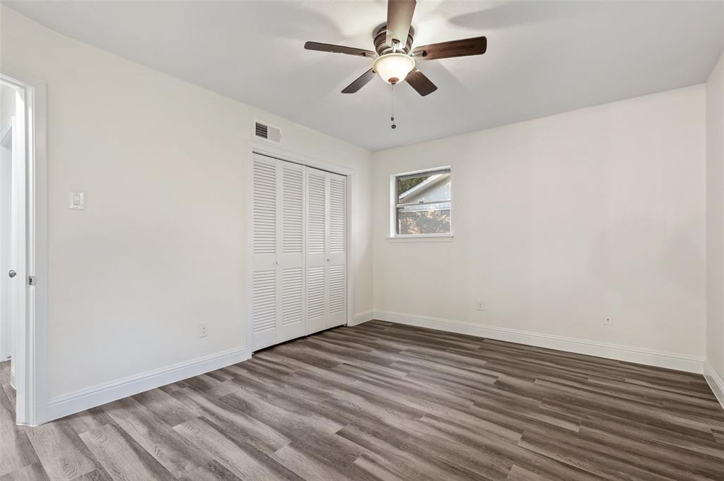 3126 Jubilee Trail Dallas, TX 75229 - Photo 15 of 38 wooden floor in an empty room with a window