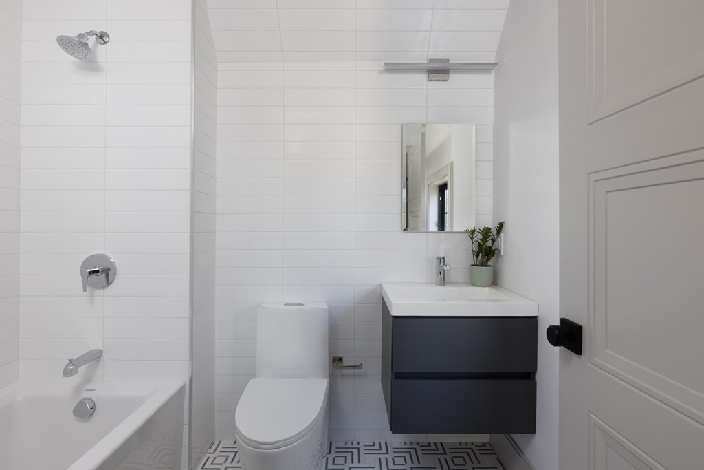 21 Naples Road, Unit 2 Brookline, MA 02446 - Photo 15 of 21 a bathroom with a sink a toilet and shower