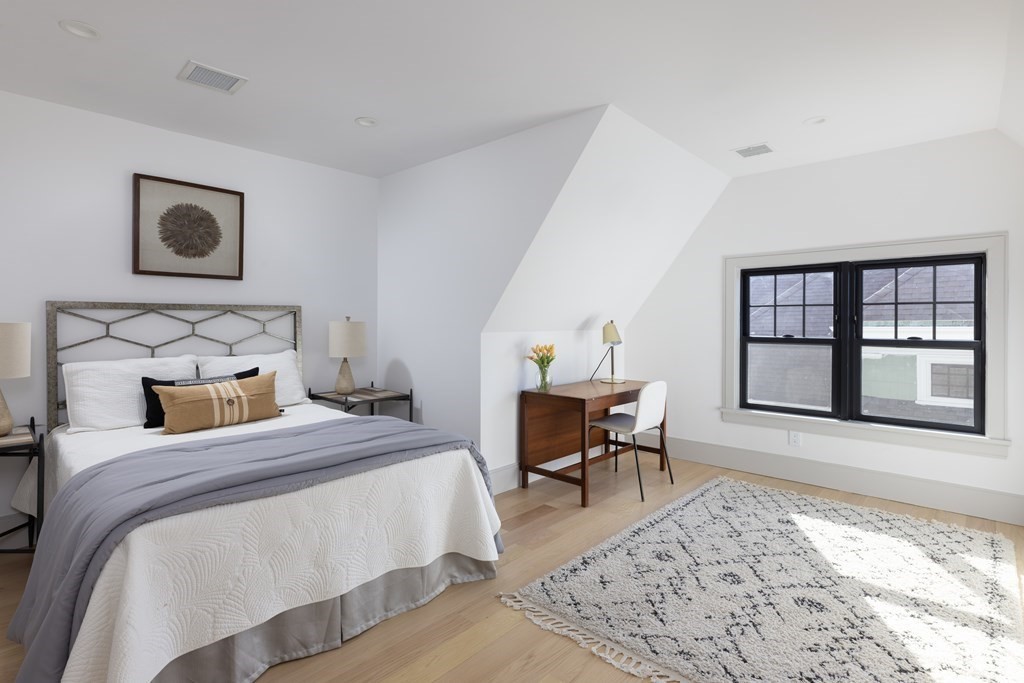 21 Naples Road, Unit 2 Brookline, MA 02446 - Photo 16 of 21 a bedroom with a bed and a large window with chair