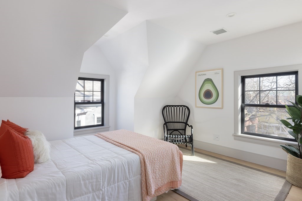 21 Naples Road, Unit 2 Brookline, MA 02446 - Photo 18 of 21 a bedroom with a bed and windows