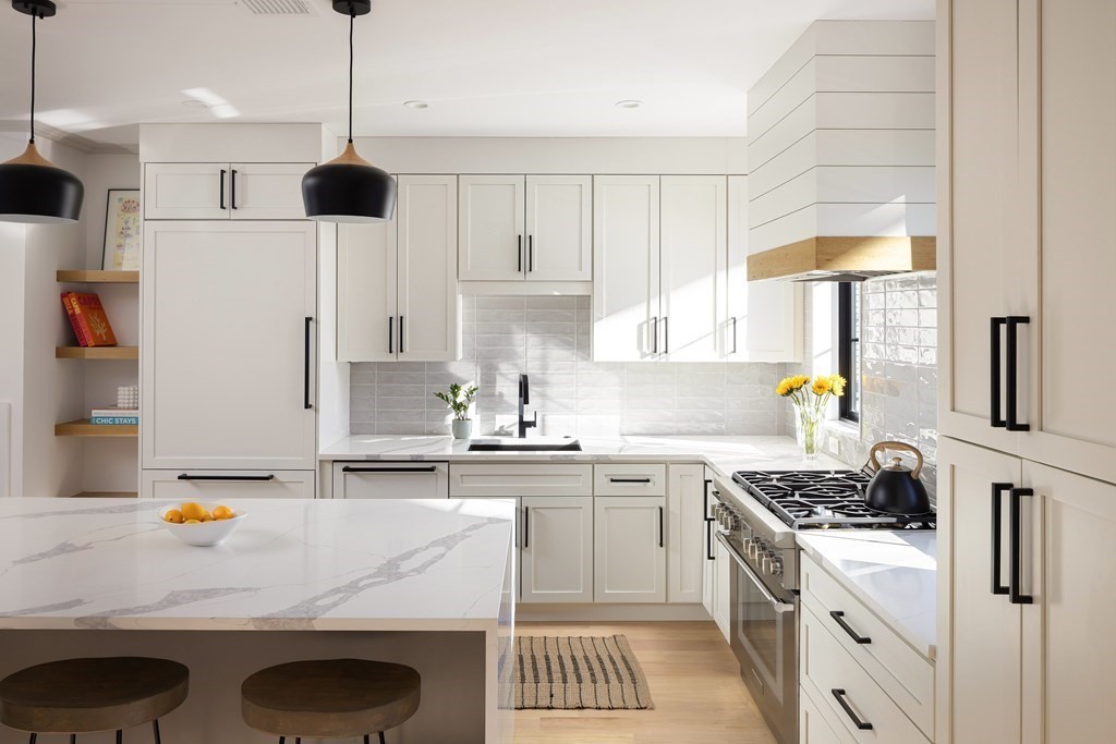 21 Naples Road, Unit 2 Brookline, MA 02446 - Photo 3 of 21 a kitchen with stainless steel appliances granite countertop a sink a stove and a refrigerator