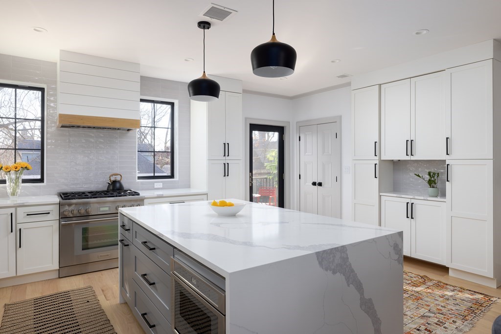 21 Naples Road, Unit 2 Brookline, MA 02446 - Photo 4 of 21 a kitchen with stainless steel appliances a sink stove and refrigerator