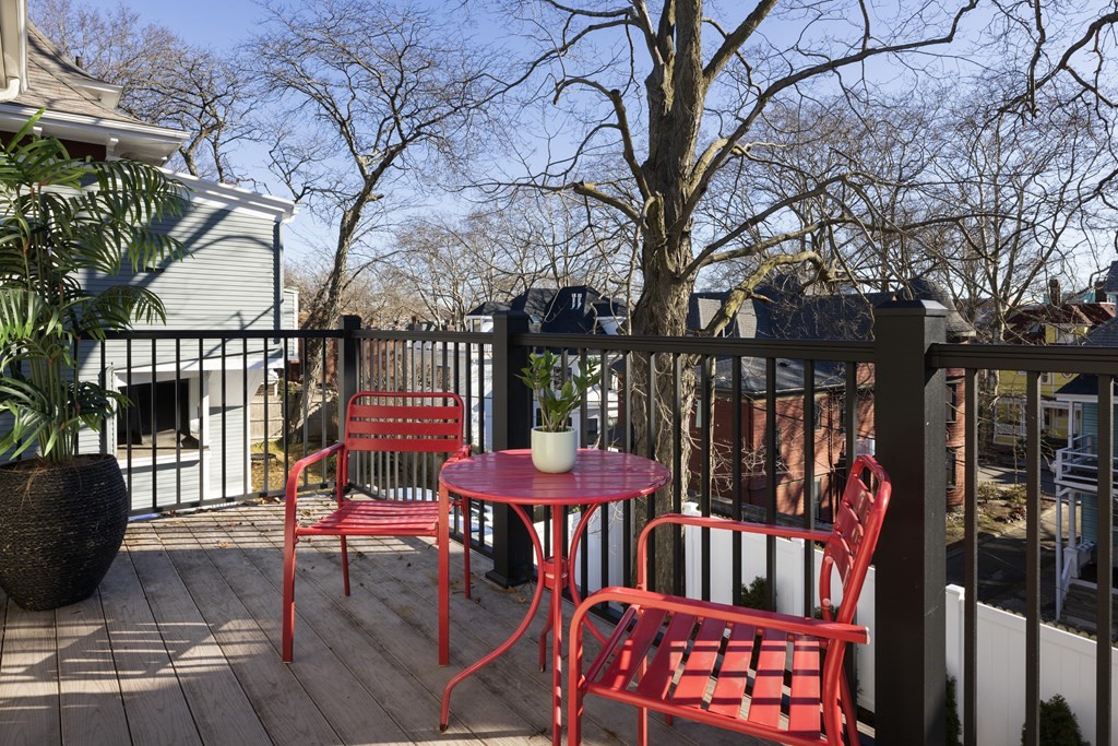 21 Naples Road, Unit 2 Brookline, MA 02446 - Photo 5 of 21 a balcony with wooden floor table and chairs