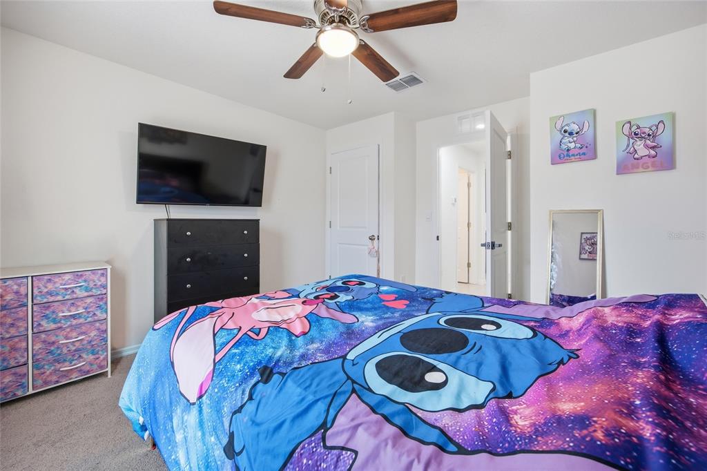 16402 Southwest 17th Terr Road Ocala, FL 34473 - Photo 11 of 36 a bedroom with a bed and a flat screen tv