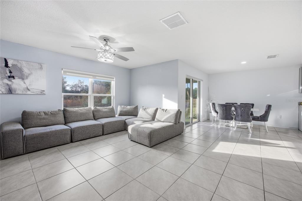 16402 Southwest 17th Terr Road Ocala, FL 34473 - Photo 21 of 36 a living room with furniture and a chandelier