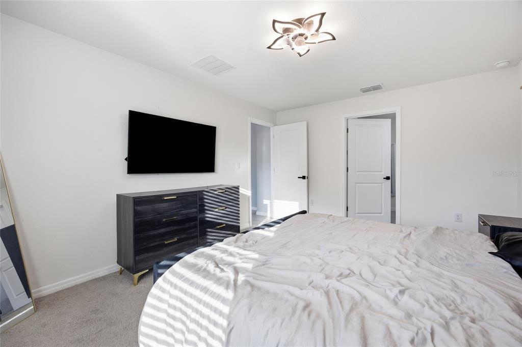 16402 Southwest 17th Terr Road Ocala, FL 34473 - Photo 23 of 36 a bedroom with a bed and a flat screen tv