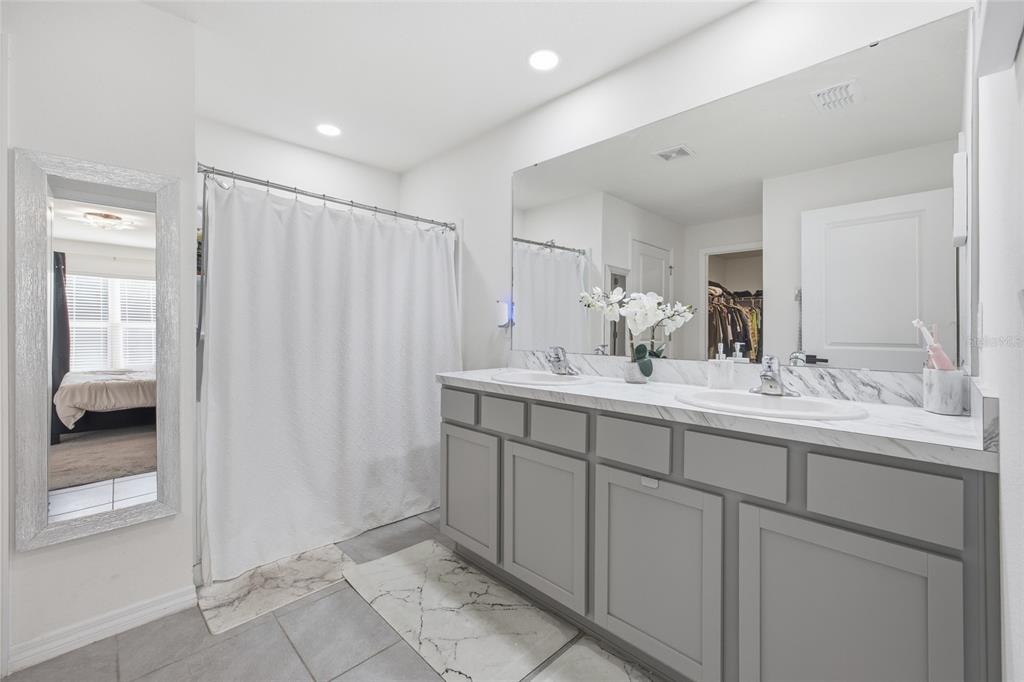 16402 Southwest 17th Terr Road Ocala, FL 34473 - Photo 24 of 36 a bathroom with a double vanity sink and a mirror