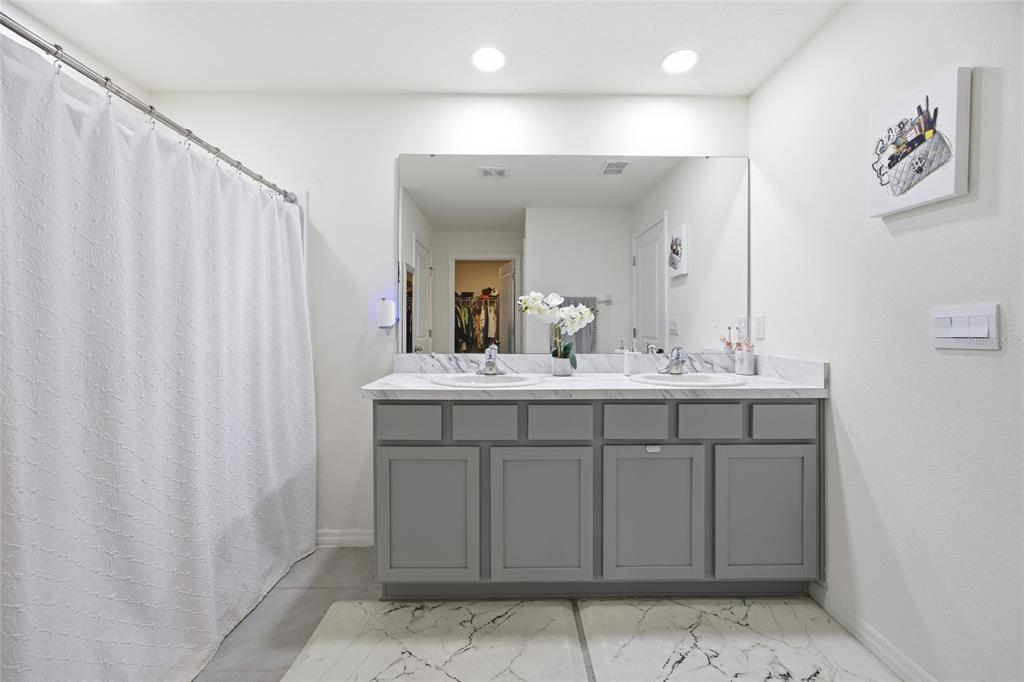 16402 Southwest 17th Terr Road Ocala, FL 34473 - Photo 25 of 36 a bathroom with a sink double vanity and a mirror