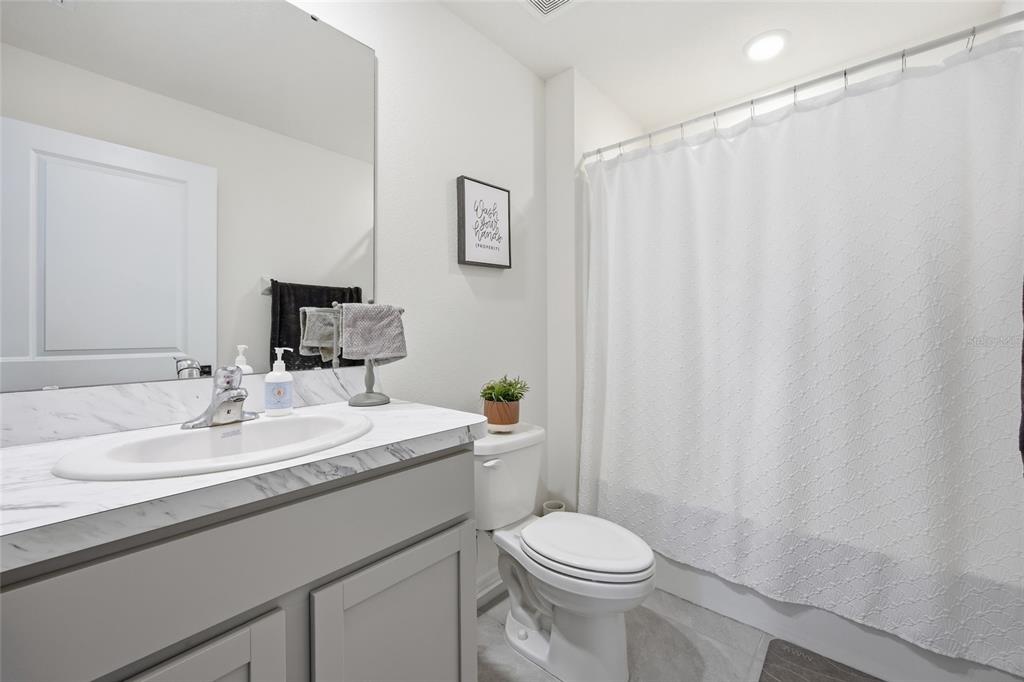 16402 Southwest 17th Terr Road Ocala, FL 34473 - Photo 7 of 36 a bathroom with a sink a toilet and a mirror