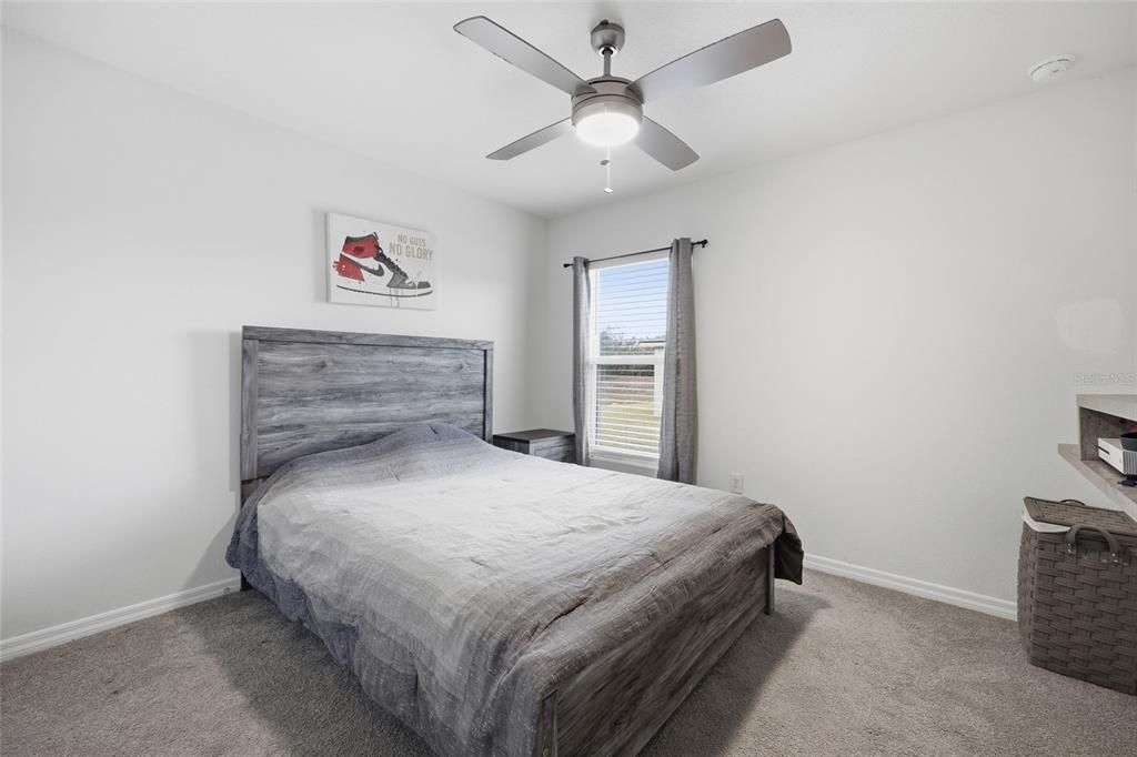 16402 Southwest 17th Terr Road Ocala, FL 34473 - Photo 8 of 36 a bedroom with a bed and a chandelier