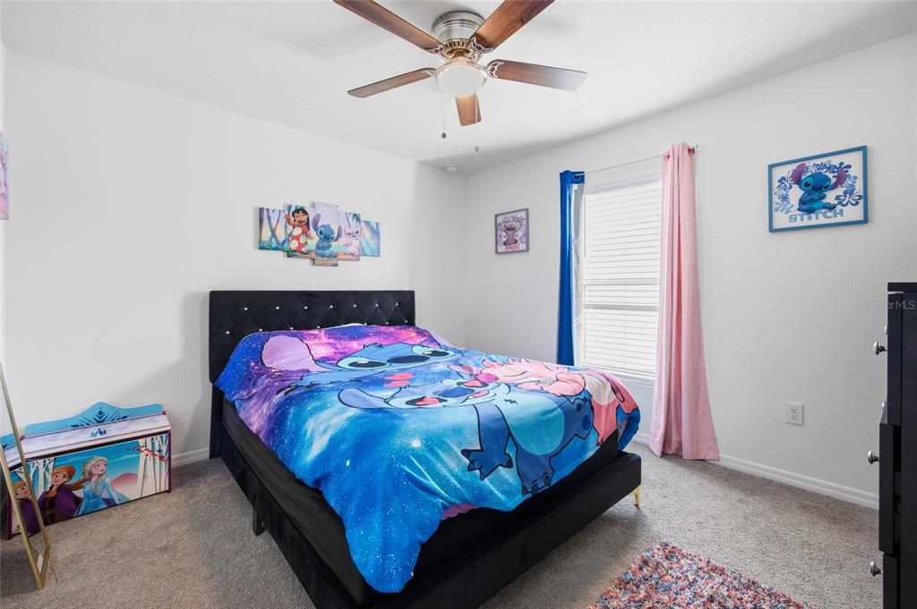 16402 Southwest 17th Terr Road Ocala, FL 34473 - Photo 10 of 36 a bedroom with a bed and a chandelier