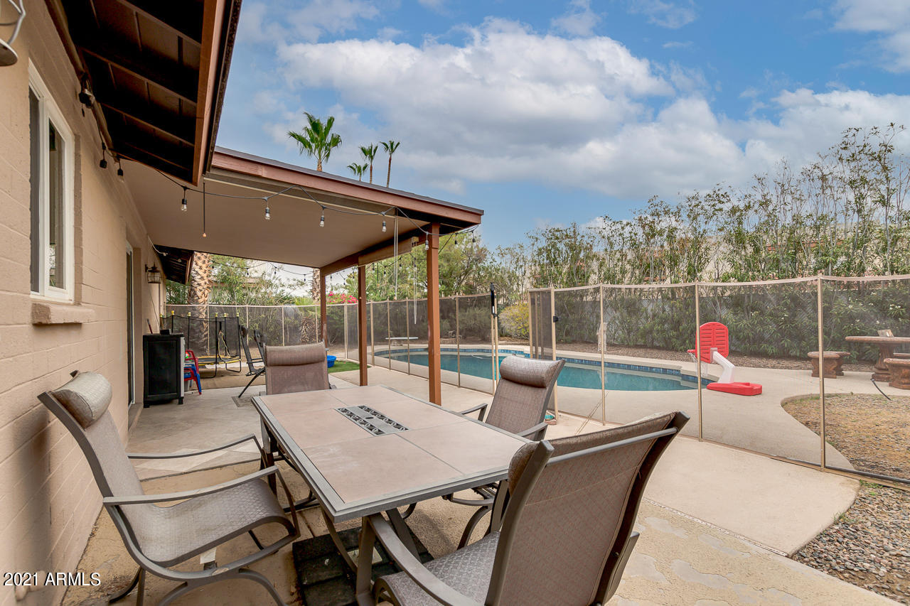 4215 West Dailey Street Phoenix, AZ 85053 - Photo 27 of 32 a view of a patio with a table chairs and a backyard