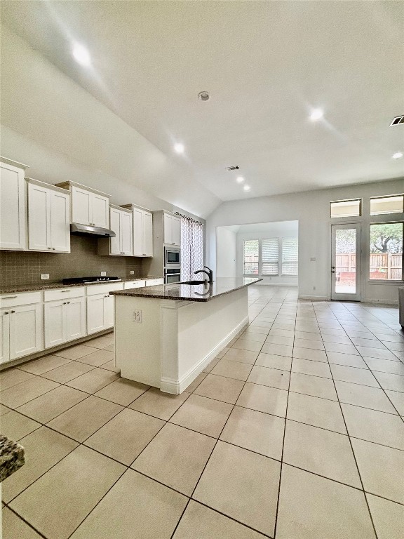 13326 Lake Chesdin Road Houston, TX 77044 - Photo 12 of 29 a large white kitchen with kitchen island granite countertop a large counter top space and a window