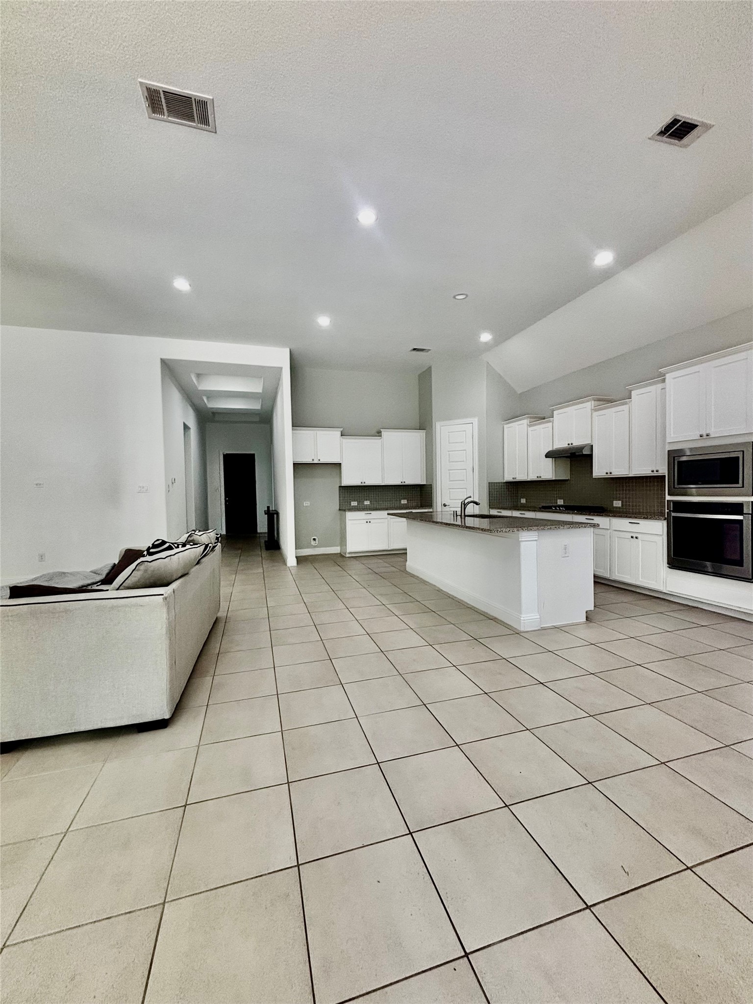 13326 Lake Chesdin Road Houston, TX 77044 - Photo 14 of 29 a large white kitchen with stainless steel appliances granite countertop a stove top oven a sink dishwasher and a refrigerator