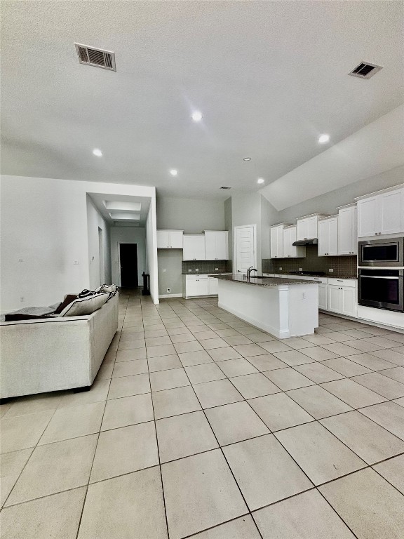 13326 Lake Chesdin Road Houston, TX 77044 - Photo 14 of 29 a large white kitchen with stainless steel appliances granite countertop a stove top oven a sink dishwasher and a refrigerator