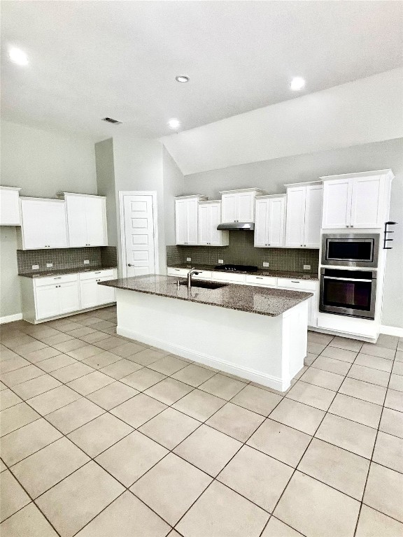 13326 Lake Chesdin Road Houston, TX 77044 - Photo 15 of 29 a large kitchen with stainless steel appliances a stove a sink a microwave and cabinets