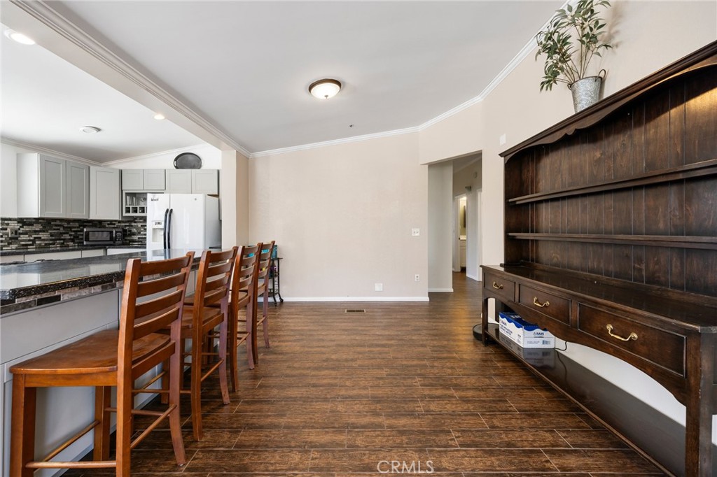 33415 Oracle Hill Road Palmdale, CA 93550 - Photo 12 of 44 a kitchen with stainless steel appliances a stove a table and chairs