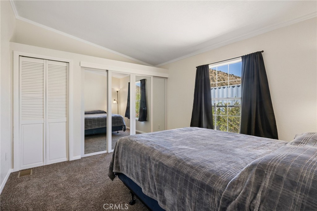 33415 Oracle Hill Road Palmdale, CA 93550 - Photo 17 of 44 a spacious bedroom with a bed and a dresser