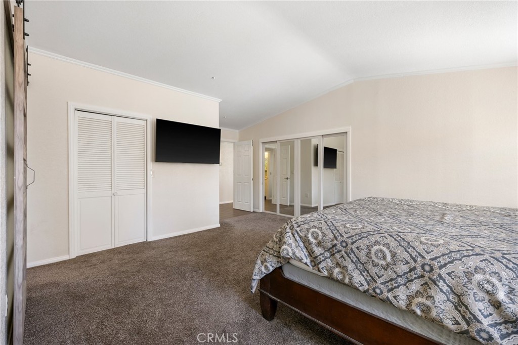 33415 Oracle Hill Road Palmdale, CA 93550 - Photo 19 of 44 a bedroom with a bed and a flat screen tv