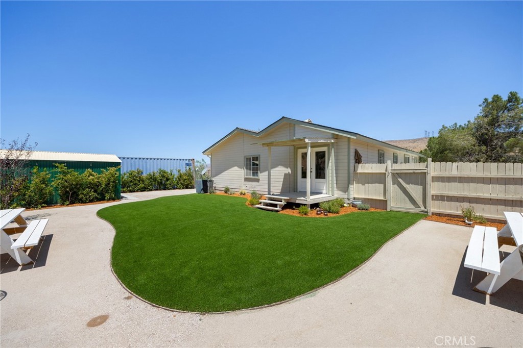 33415 Oracle Hill Road Palmdale, CA 93550 - Photo 2 of 44 a view of a house with backyard sitting area and garden