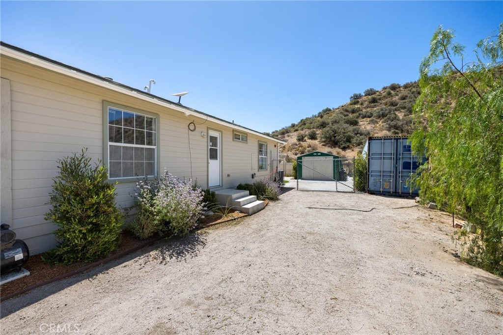 33415 Oracle Hill Road Palmdale, CA 93550 - Photo 26 of 44 a front view of a house with garden