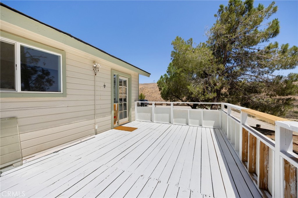 33415 Oracle Hill Road Palmdale, CA 93550 - Photo 27 of 44 a view of a balcony with wooden floor and fence