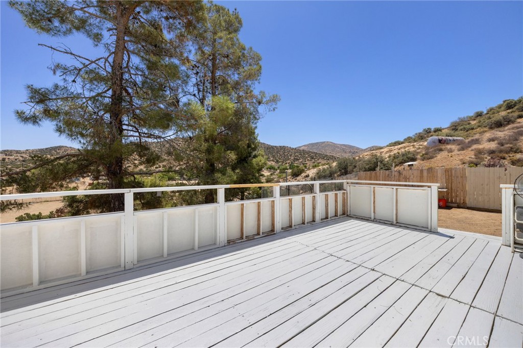 33415 Oracle Hill Road Palmdale, CA 93550 - Photo 28 of 44 a view of balcony with wooden floor and fence