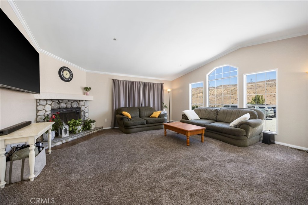 33415 Oracle Hill Road Palmdale, CA 93550 - Photo 6 of 44 a living room with furniture and a flat screen tv