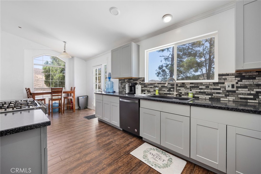 33415 Oracle Hill Road Palmdale, CA 93550 - Photo 10 of 44 a kitchen with lots of counter top space and wooden floor